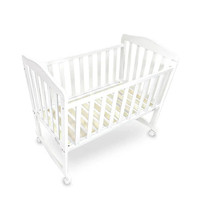 White crib with beige mattress on a white background