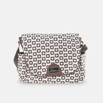 Floral patterned bag with brown accents on a light gray background