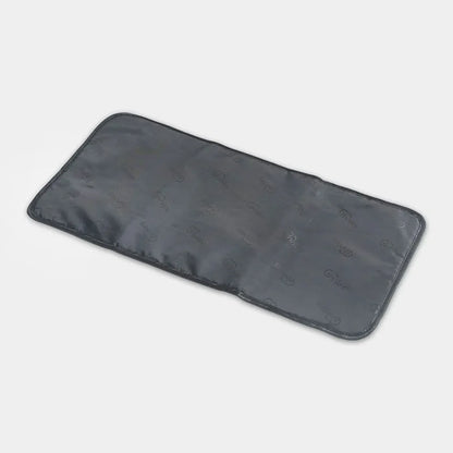 Black rectangular heating pad on a light gray background