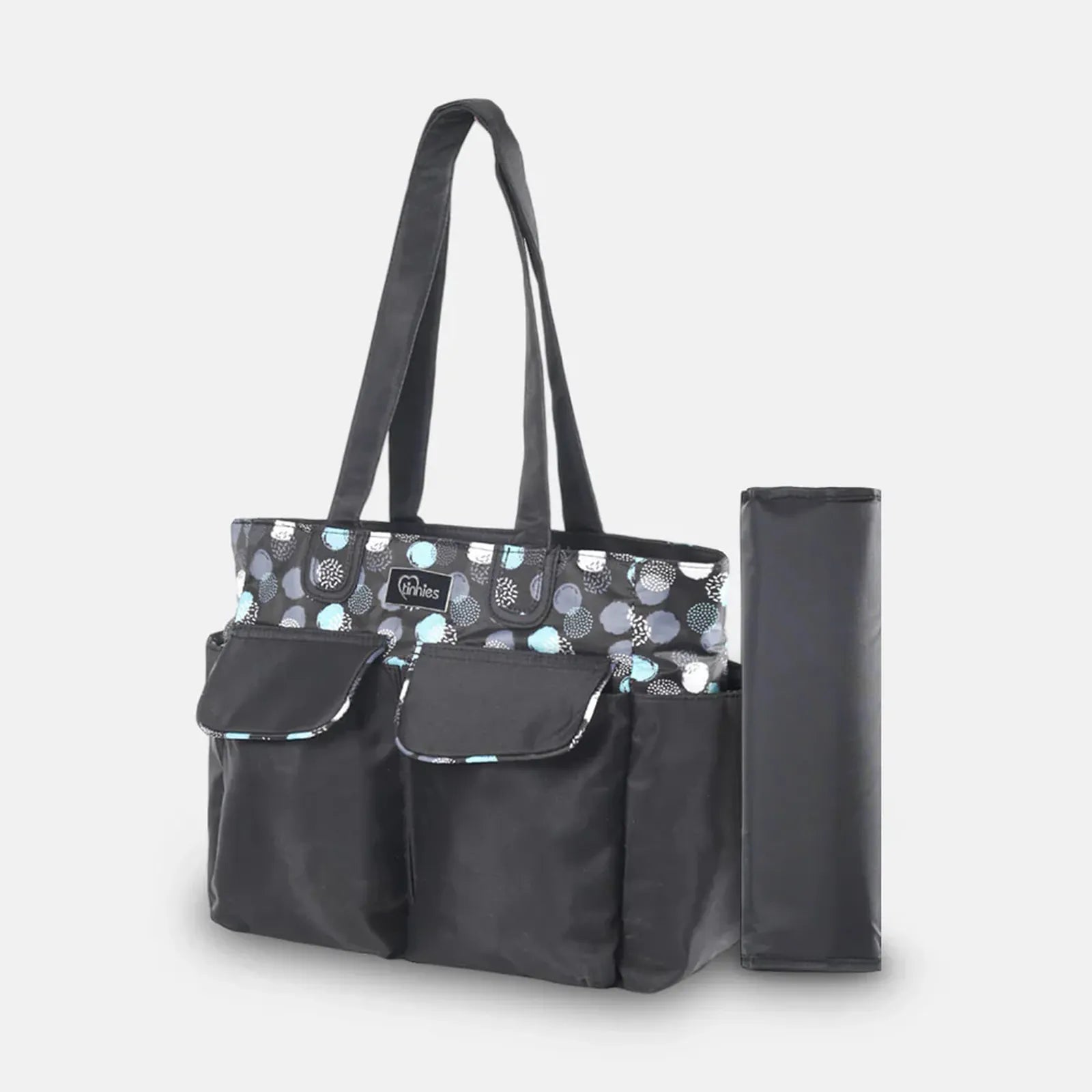 Black diaper bag with patterned top section and matching umbrella on a light gray background