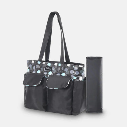 Black diaper bag with patterned top section and matching umbrella on a light gray background