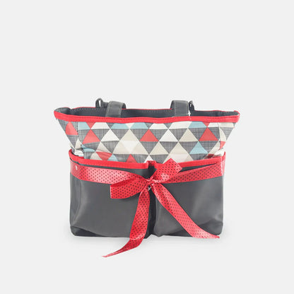 Gray bag with a red geometric patterned top section and a red ribbon on a white background
