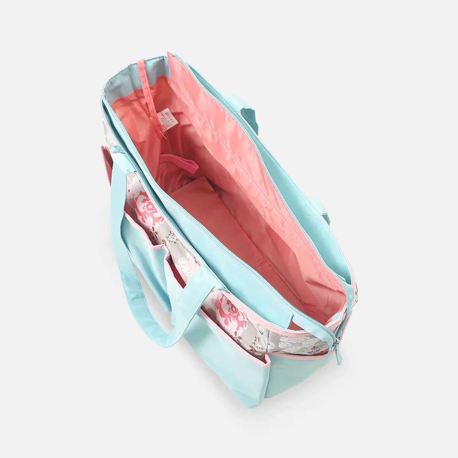 Light blue tote bag with pink interior and floral lining on a white background