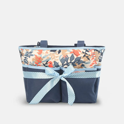 Floral-patterned bag with a navy base and light blue ribbon on a white background