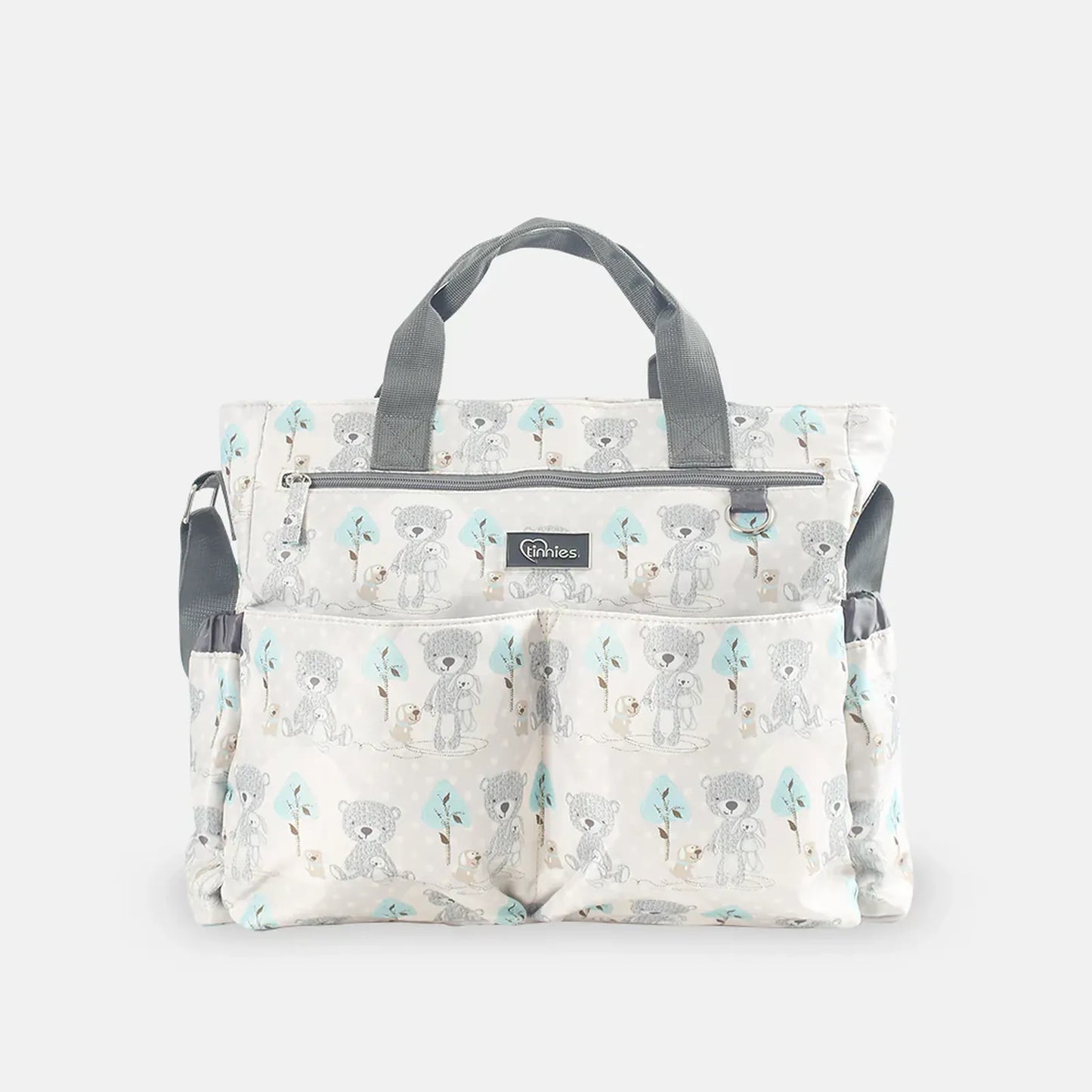Patterned diaper bag with teddy bear design on a white background
