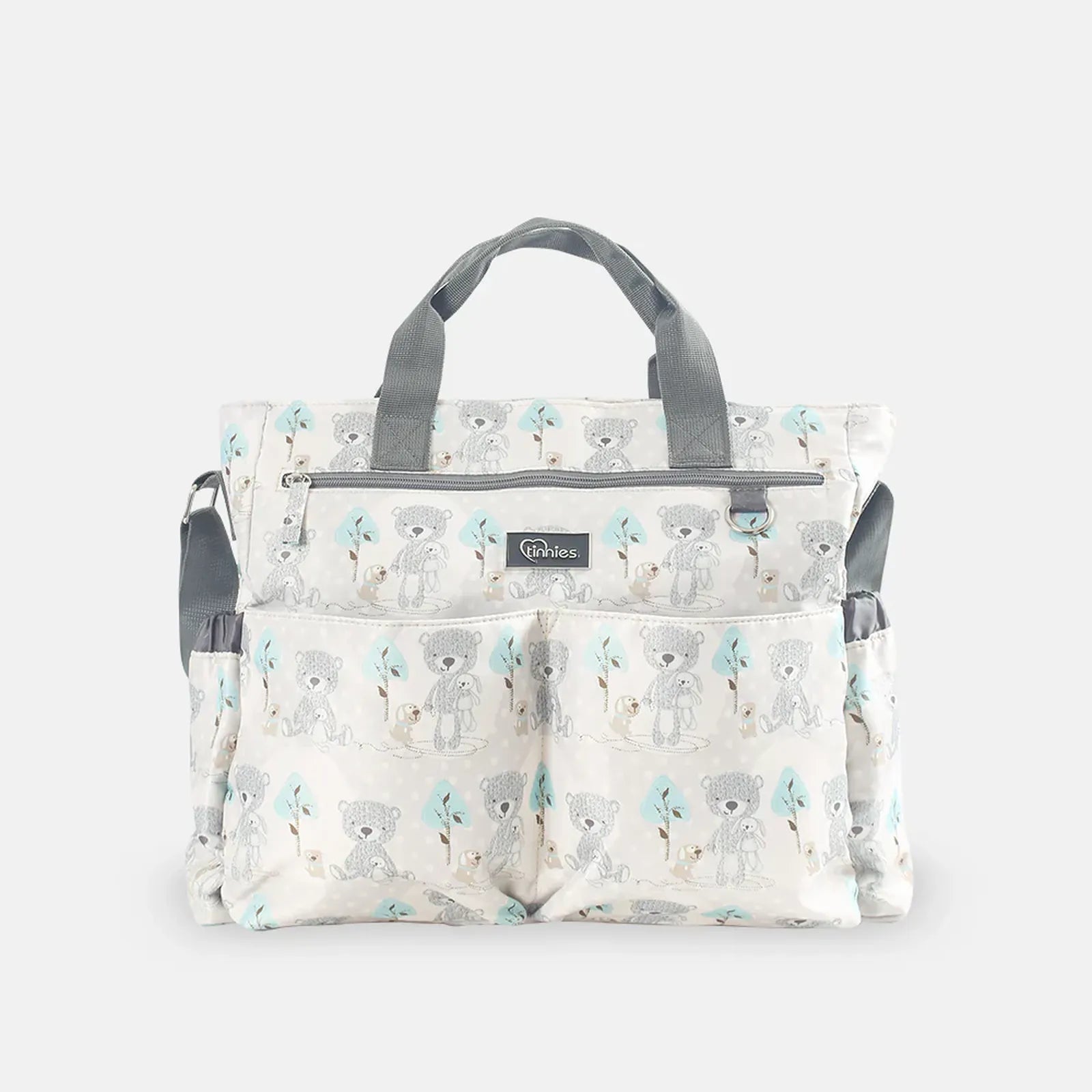 Patterned diaper bag with teddy bear design on a white background