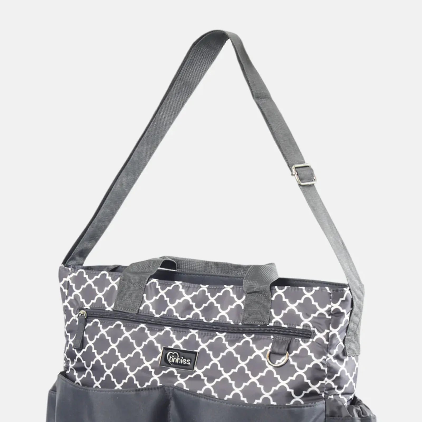 Gray and white patterned bag with a strap on a light gray background