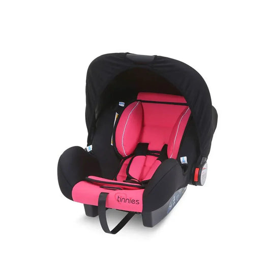 Black and pink baby car seat with canopy on a white background