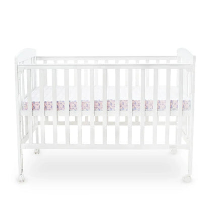 White crib with a pink and white checkered bumper pad on a white background