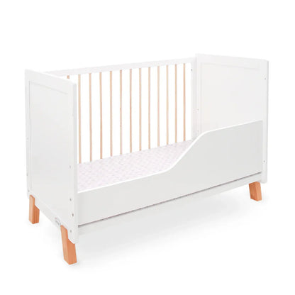 White crib with wooden legs on a white background