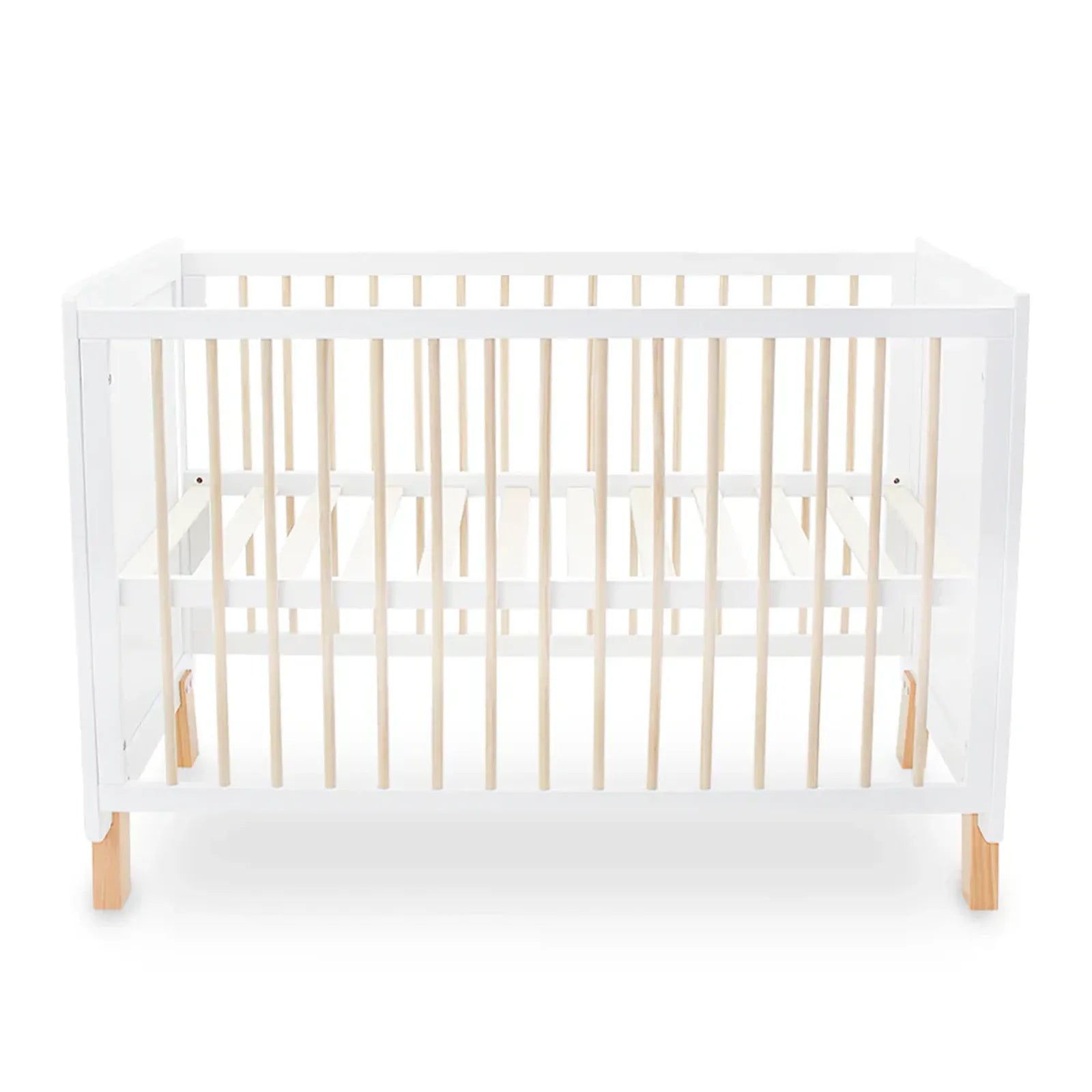 White crib with wooden legs and sides on a white background