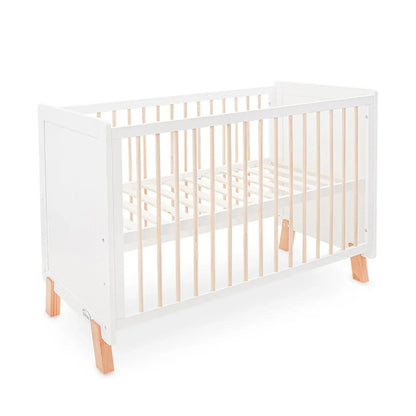White crib with wooden accents on a white background