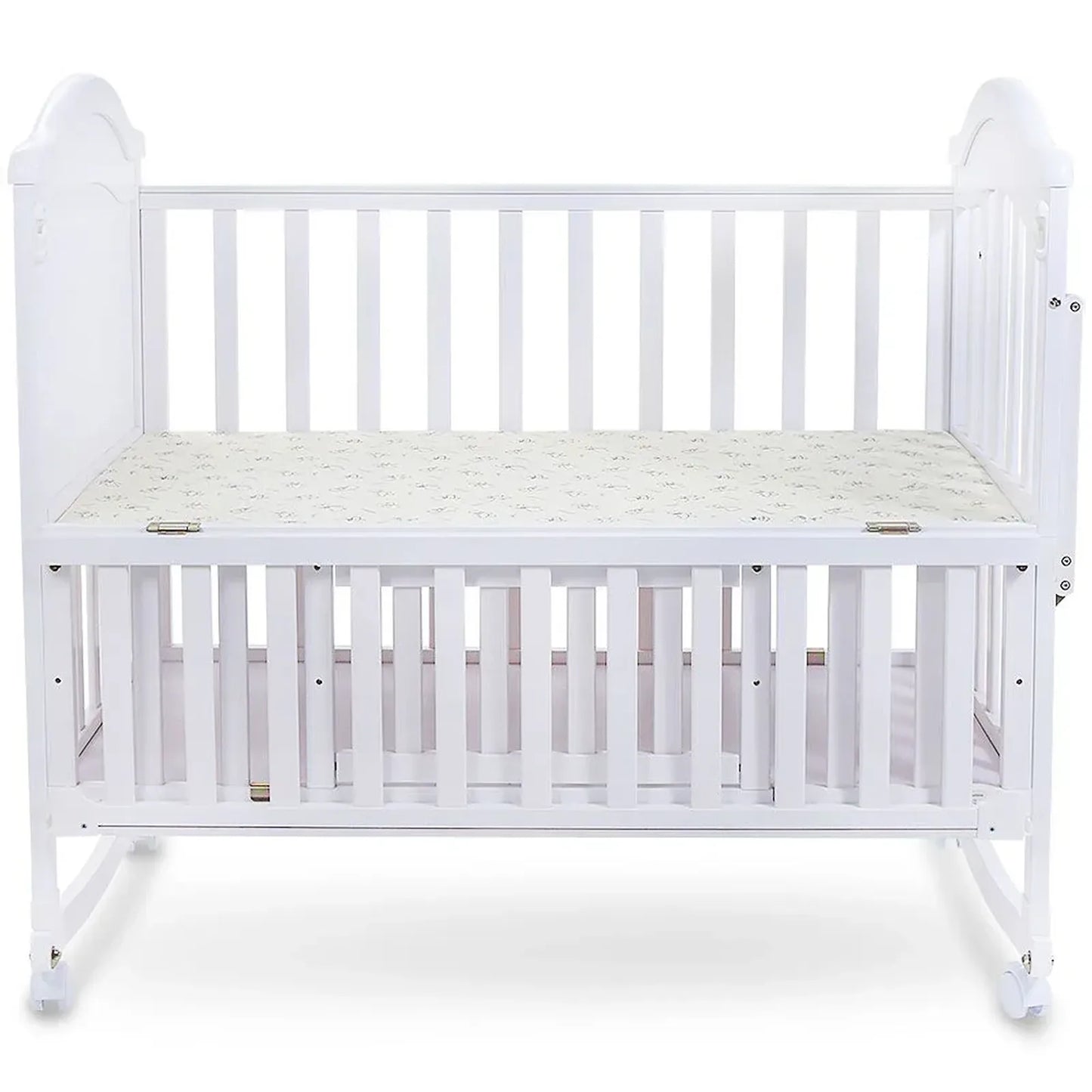 White crib with a mattress on a white background