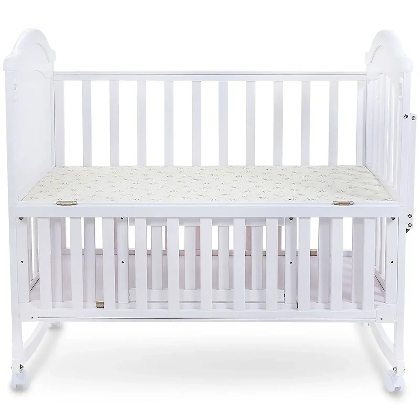 White crib with a mattress on a white background