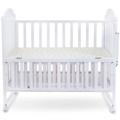 White crib with a mattress on a white background