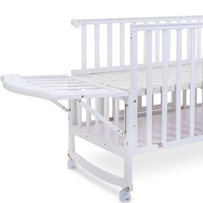 White crib with attached changing table on a white background