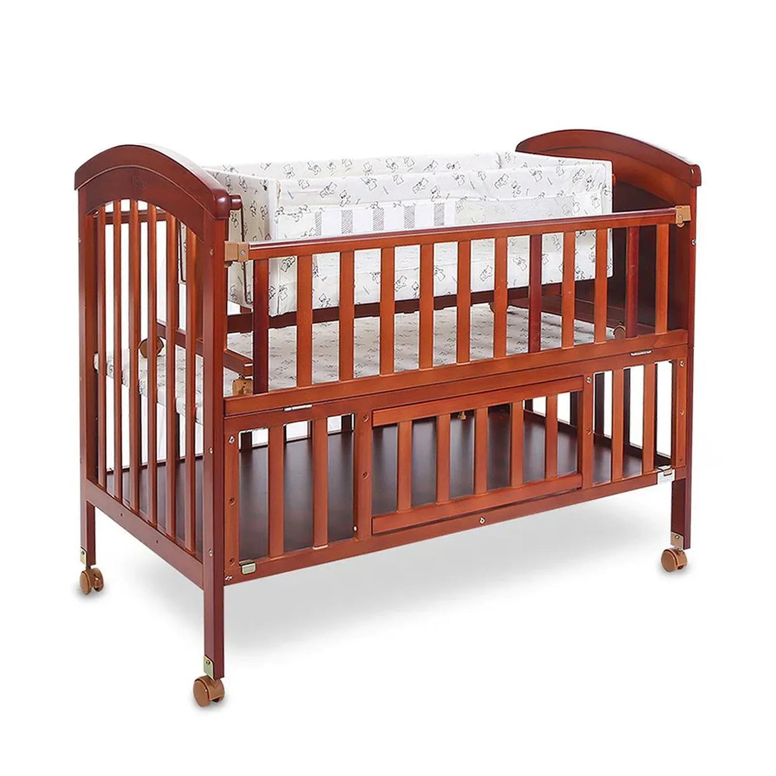 Wooden crib with white mattress on a white background