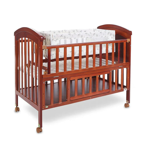 Wooden crib with white mattress on a white background