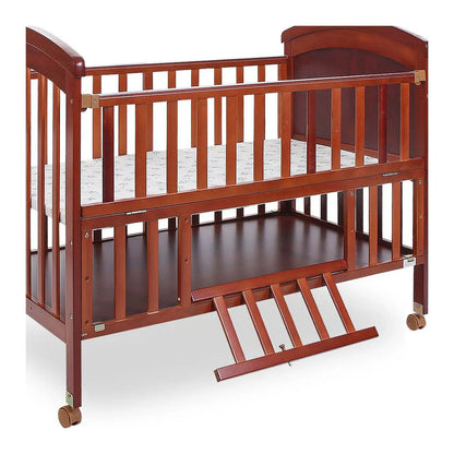 Wooden crib with a white mattress on a white background