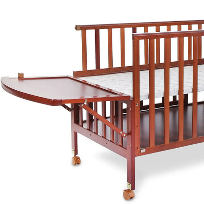 Wooden crib with a attached changing table on a white background