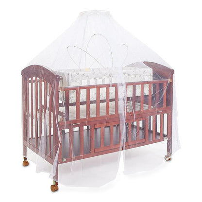Wooden crib with a transparent safety net on a white background
